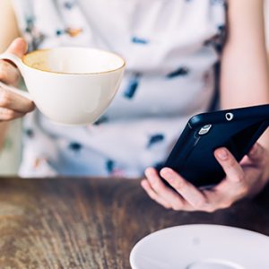 Woman with coffee and phone